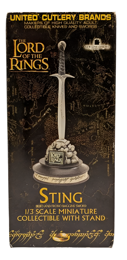 Box for 'Sting' collectible sword from 'The Lord of the Rings' series, next to a dollar bill for scale.