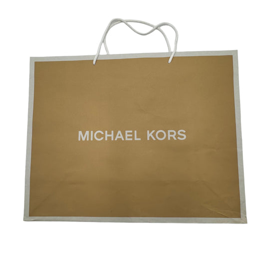 Michael Kors shopping bag on a white surface