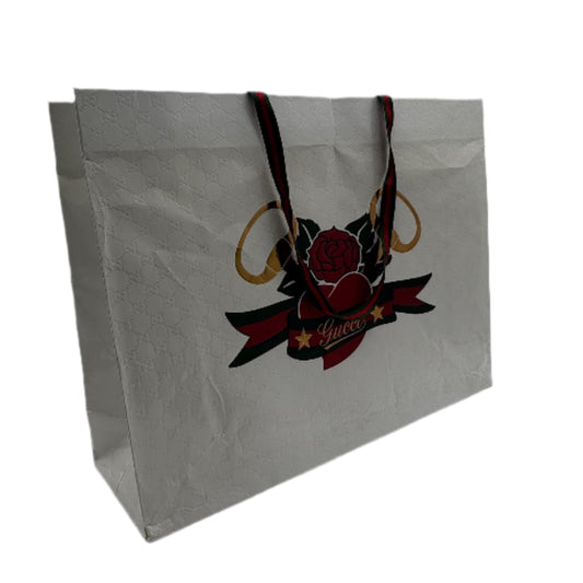 White gift bag with a red and black design on a white background
