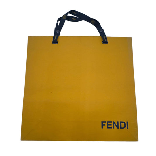 Yellow Fendi shopping bag on a white surface
