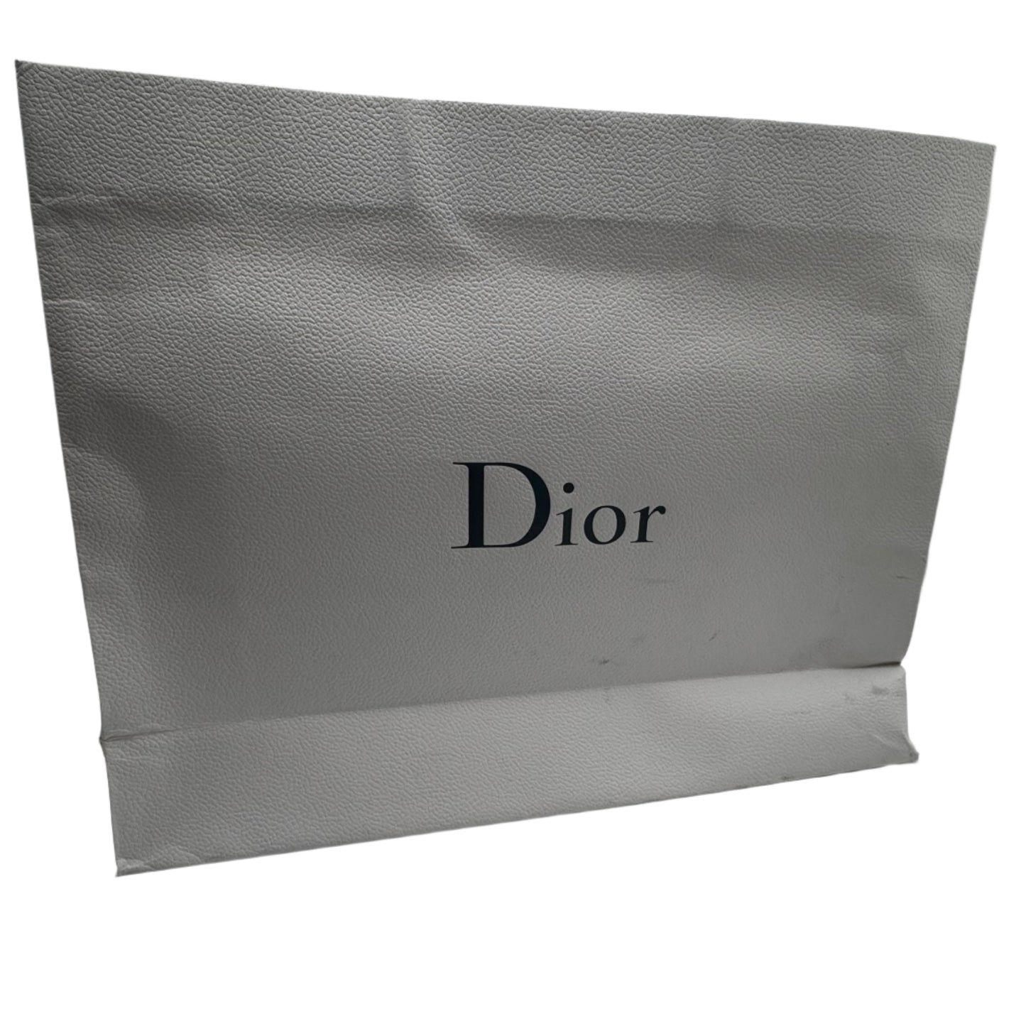 Dior shopping bag in a white room with reflective walls