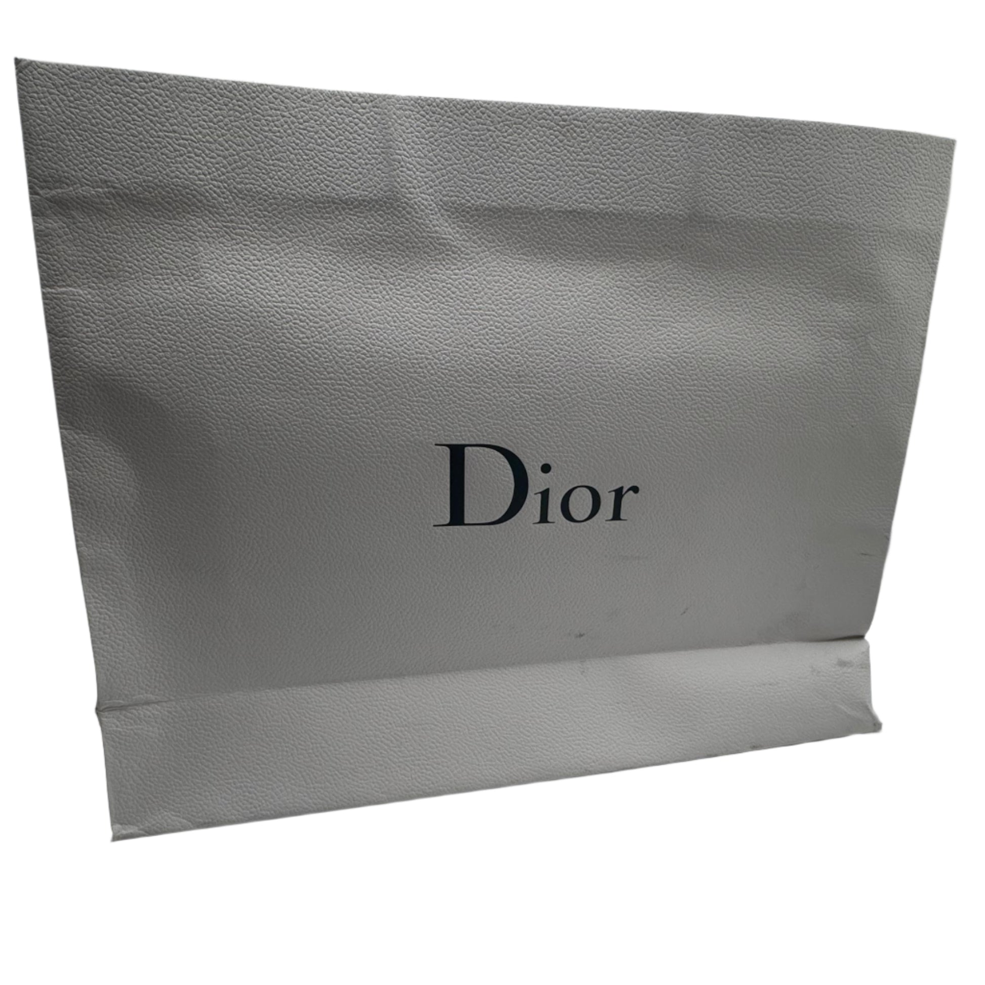 Dior shopping bag in a white room with reflective walls