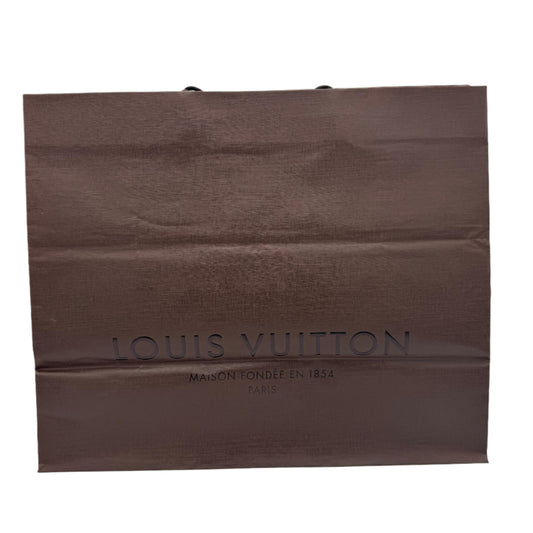 Brown Louis Vuitton shopping bag on a white background