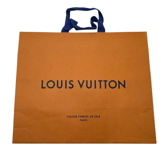 Louis Vuitton paper bag on a white surface